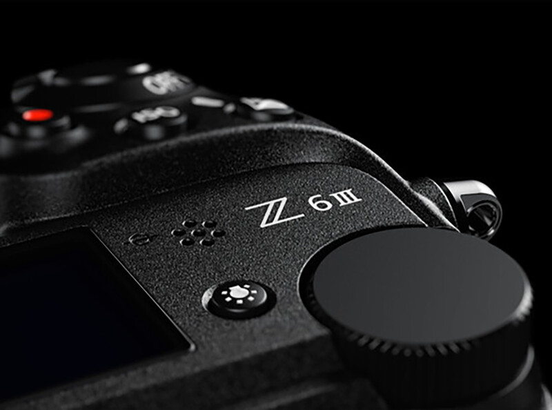 Nikon Z6III mirrorless camera body shown in profile against a black background with lens cap visible.
