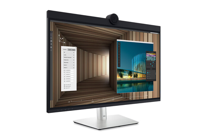 Monitor displaying split-screen workspace with file organization panel and architectural photography of illuminated building reflected in water.