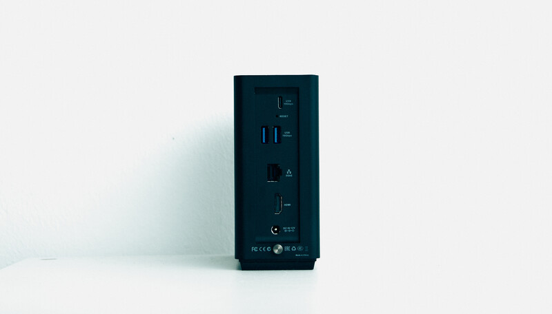 Dark compact desktop computer tower with minimalist front panel and illuminated digital display elements.
