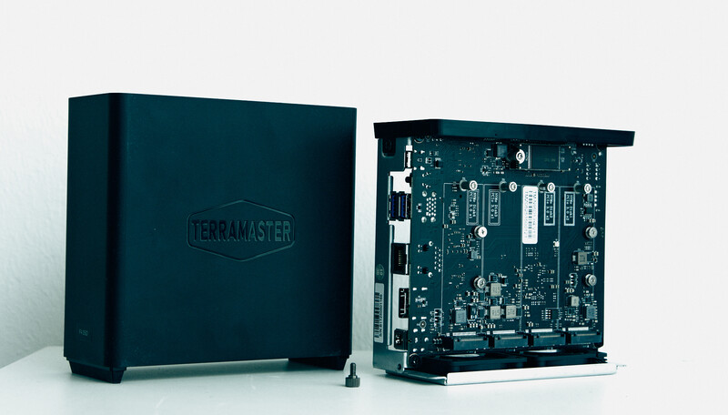 TerraMaster NAS unit shown closed and with internal circuit board exposed side-by-side.