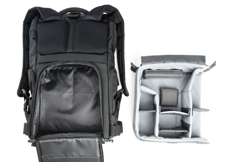 Black camera backpack with removable divider insert displaying internal organization compartments.