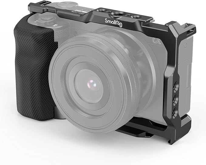 Illustration of a camera cage rig with black aluminum frame and grip attachments mounted on a mirrorless camera body.