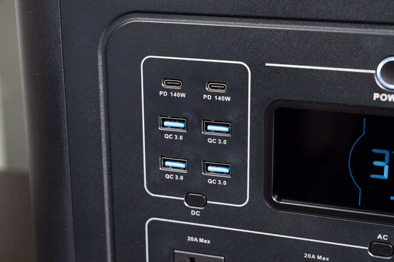 Close-up of a portable power station's port panel showing USB-C PD and QC charging ports with DC output specifications.