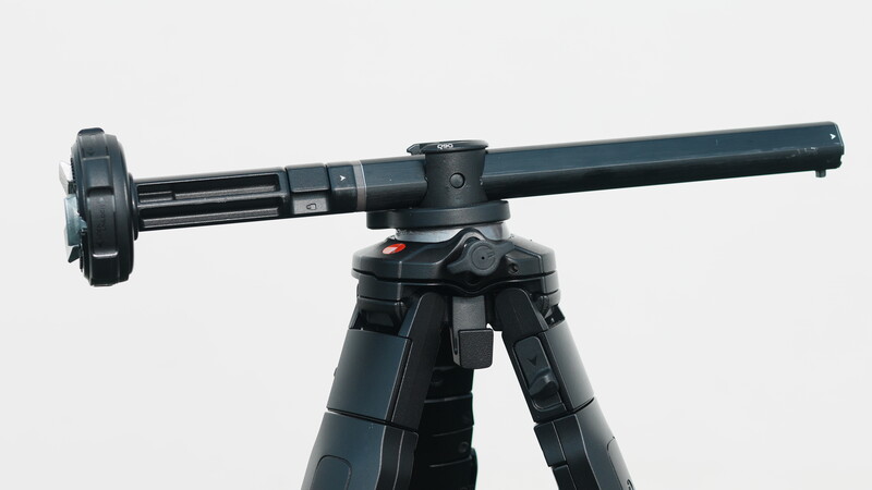 Professional tripod head with panoramic arm and fluid pan-tilt mechanism mounted on dark legs.
