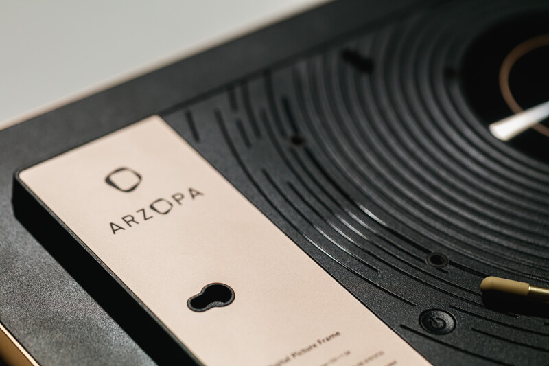Close-up of ARCOPA brand camera lens cap on top of a vinyl record turntable.