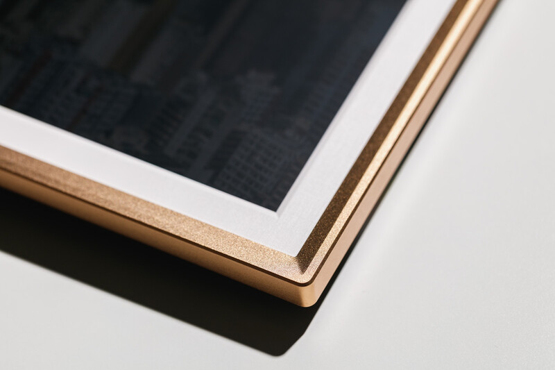 Close-up detail of a tablet device with wooden frame and white border against white background.