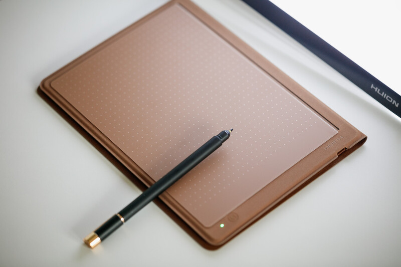 Tan leather notebook with black stylus pen resting on open page.