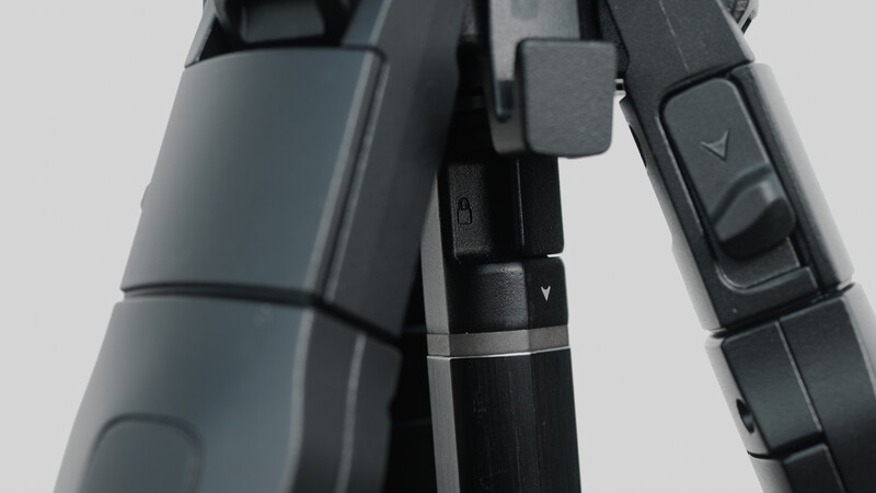 Close-up of a camera gimbal stabilizer showing articulated arms and control buttons against a neutral background.