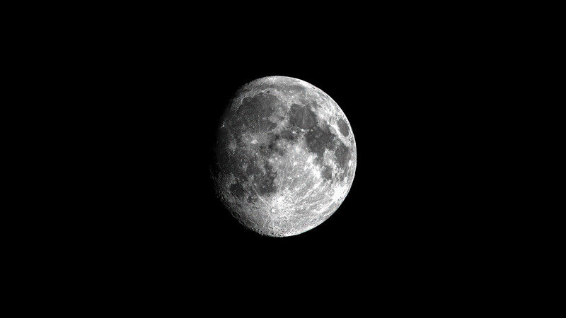 Full moon against black sky showing detailed surface features and craters.