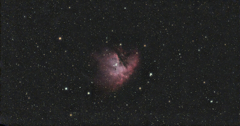 Pink and magenta nebula with bright star clusters against a dark starfield.