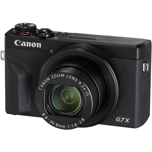 Canon PowerShot G7X Mark II compact digital camera with retractable zoom lens against white background.