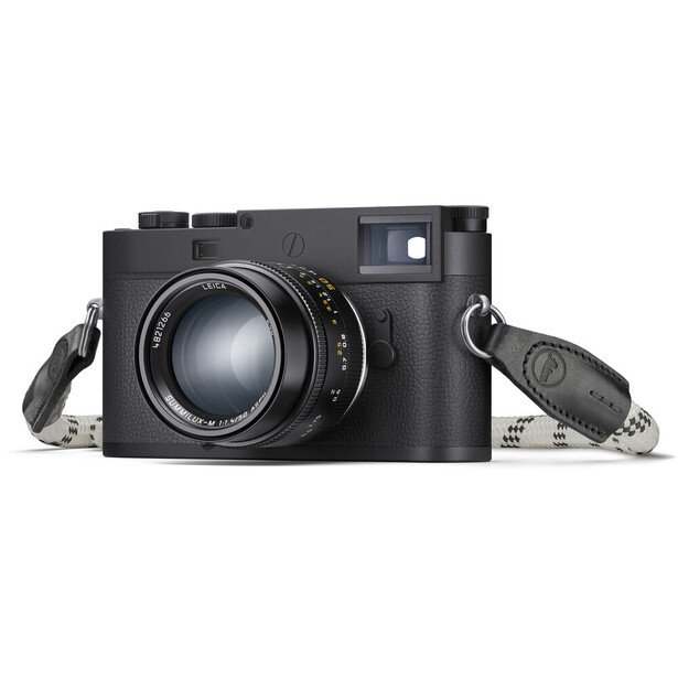 Black rangefinder camera with standard lens and two accessories against white background.