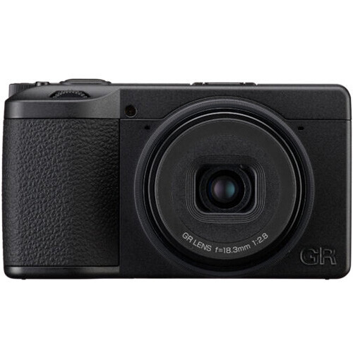 Compact digital camera with black body, textured grip, and fixed prime lens against white background.