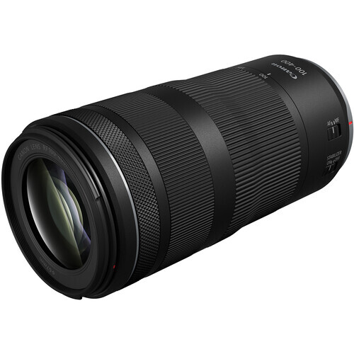 Black telephoto lens with ribbed focus and zoom rings against white background.
