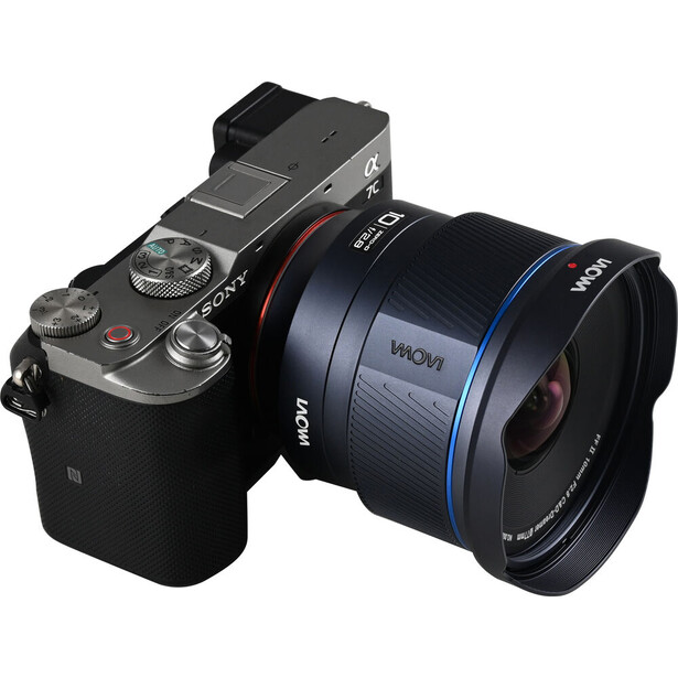 Mirrorless camera with wide-angle lens attached, shown from three-quarter view against white background.