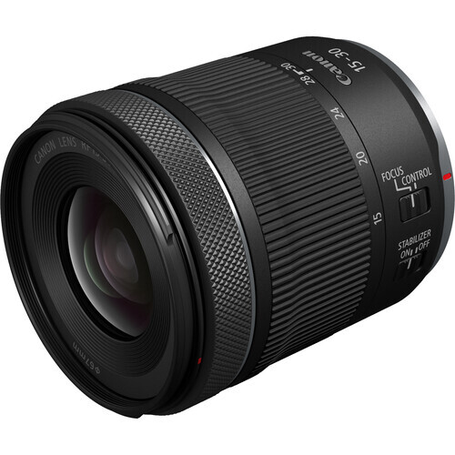 Canon RF-mount telephoto zoom lens with textured grip ring and distance scale markings.