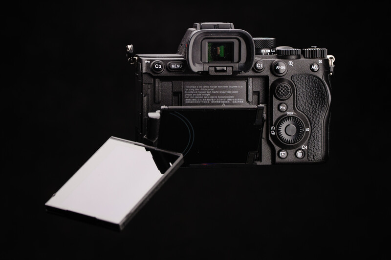 Mirrorless camera with articulating screen displayed against black background.