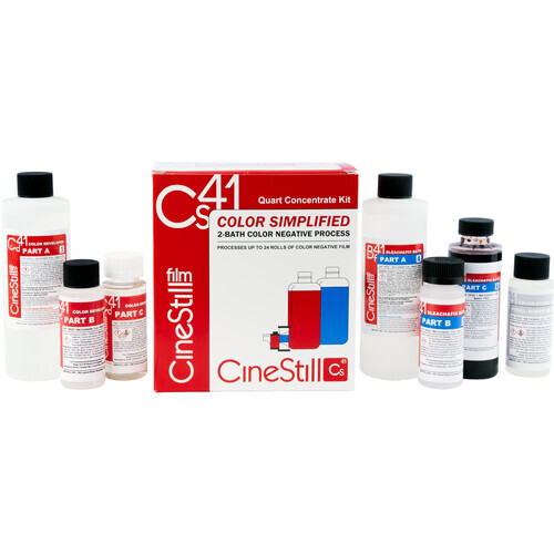 Cine Still color grading chemistry kit with bottles, boxes, and chemical containers arranged on white surface.