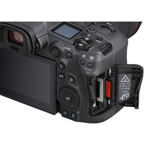 Professional video camera shown from overhead with dual SD card slots open on the right side panel.