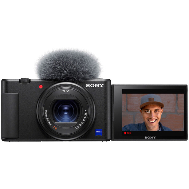 Sony ZV-1F compact camera with flip screen displaying a video call, shown with microphone attachment.