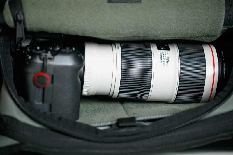 Canon RF 70-200mm f/2.8L IS USM telephoto lens stored in a gray camera bag with black foam padding.