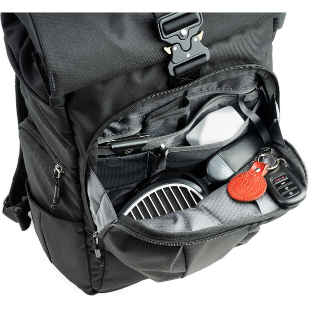 Open camera backpack displaying organized gear compartments with camera body, lenses, and accessories inside.