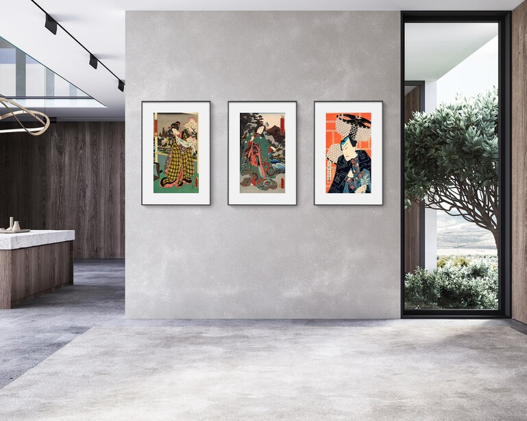 Three framed vintage Japanese woodblock prints displayed on a light gray wall above polished concrete flooring.
