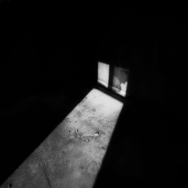 A black and white abstract image of light and shadow
