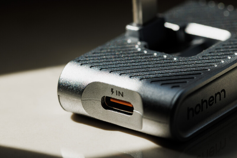 Close-up of a USB-C port on a camera or photography device with textured black grip surface.