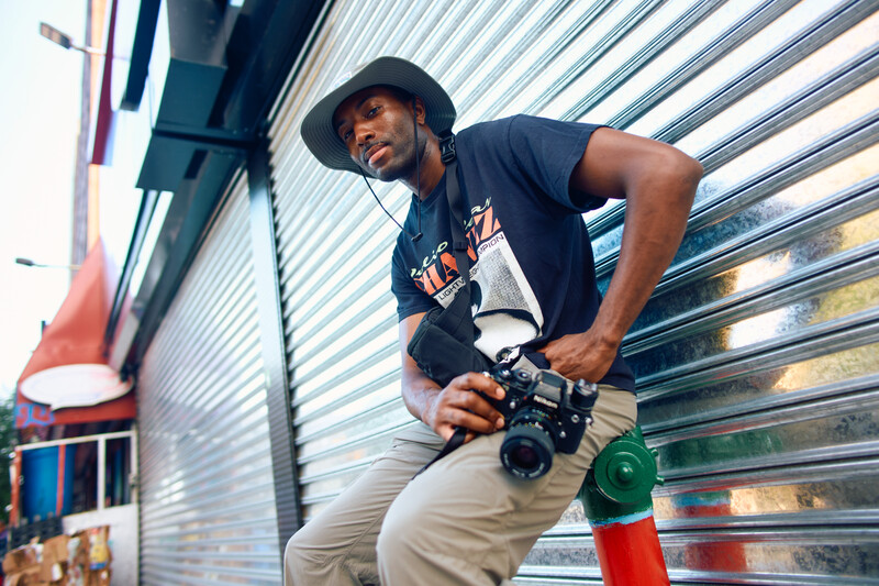 Man with camera sitting outside