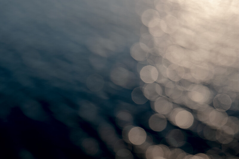 Out-of-focus bokeh lights creating soft circles against dark and light tones.