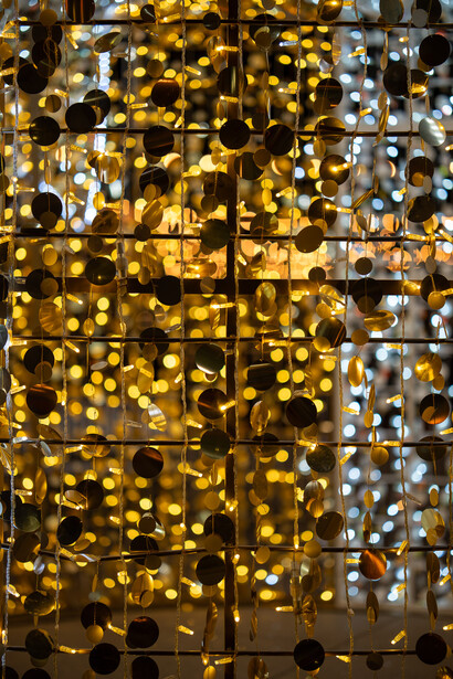 Warm golden bokeh lights creating layered depth across a grid-divided dark background.