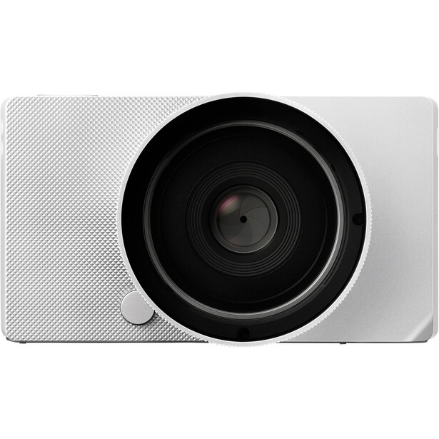 White compact camera with large black lens and textured grip surface.