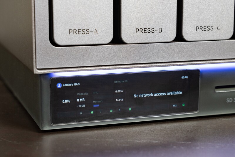 Close-up of a device's front panel with three buttons labeled PRESS-A, PRESS-B, and PRESS-C, and a digital display screen showing network status.