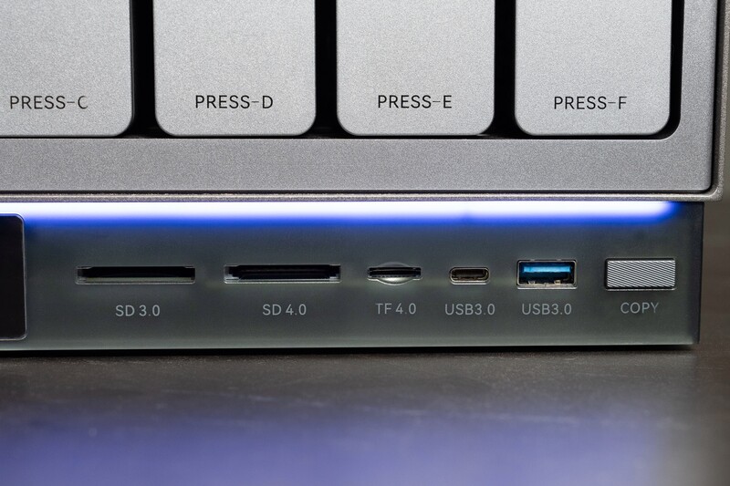 Close-up of computer I/O ports including SD card slots, USB ports, and a copy button on a keyboard or device.