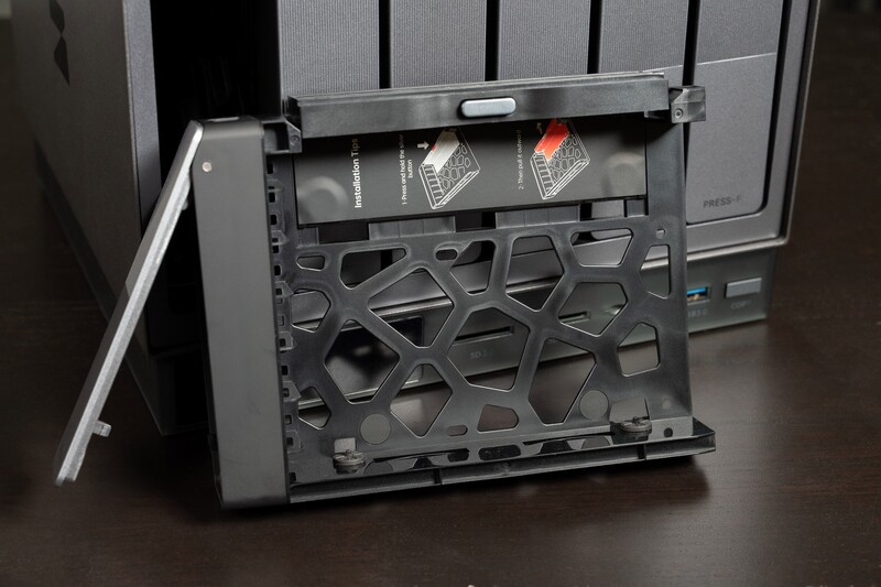 Open computer case showing interior with geometric cutout pattern on side panel and visible cooling components.
