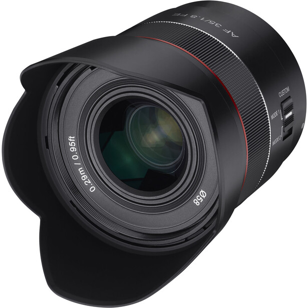 Telephoto lens with lens hood attached, showing front optics and focus ring against dark background.