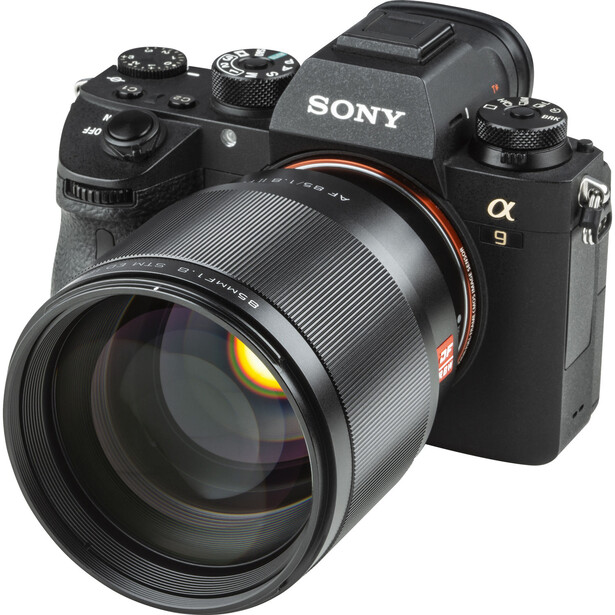Sony α9 mirrorless camera with attached telephoto lens featuring red accents on the barrel.