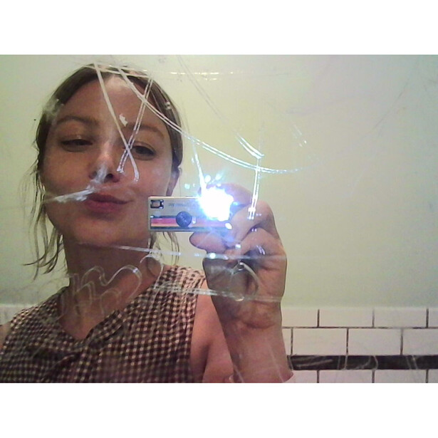 Woman holding a clear acrylic box with blue LED light source creating a bright glow effect.