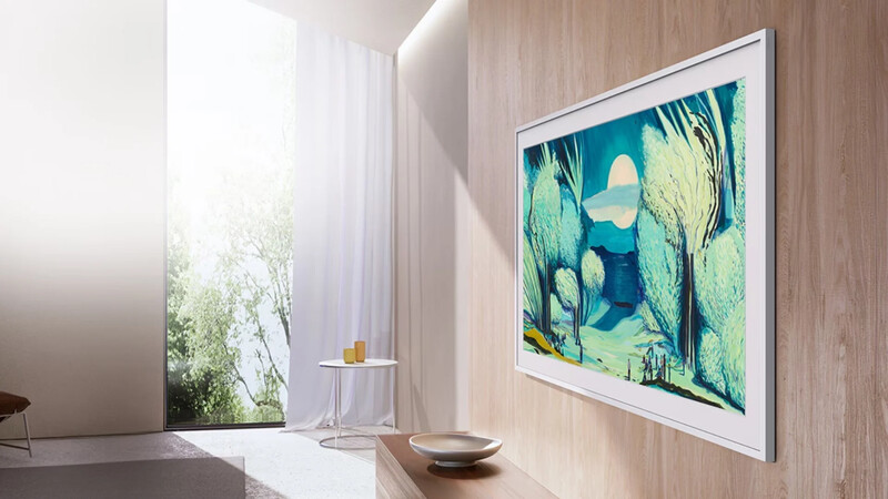 Framed landscape artwork with teal and green tones displayed on wooden wall paneling in minimalist interior.