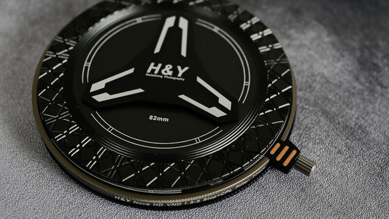 H&Y 82mm camera lens filter with three-blade design and textured black housing.