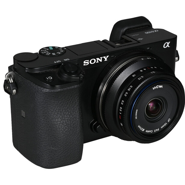 Sony α mirrorless camera with attached prime lens on white background.