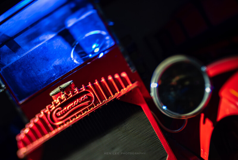 Close-up of neon tube lighting with blue and red glowing glass tubes against dark background.