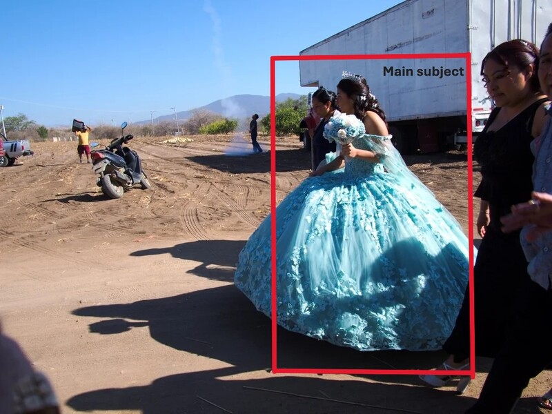 Woman in turquoise ball gown dress standing outdoors in a dusty area near a truck.