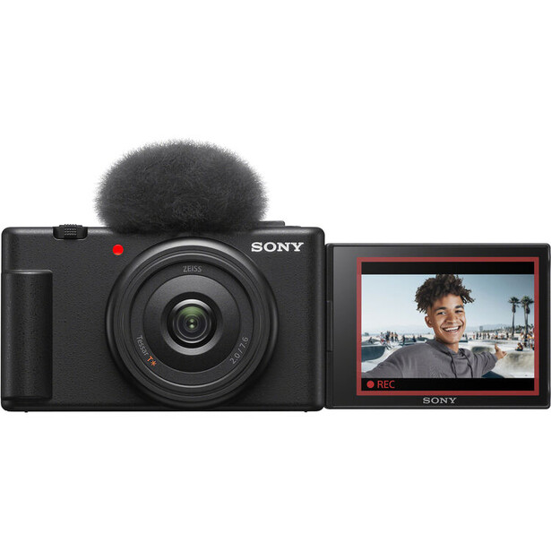 Sony ZV-1F compact vlogging camera with attached microphone and articulating LCD screen displaying a portrait subject.