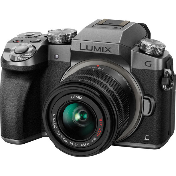 Panasonic Lumix G mirrorless camera with standard zoom lens attached, shown against white background.
