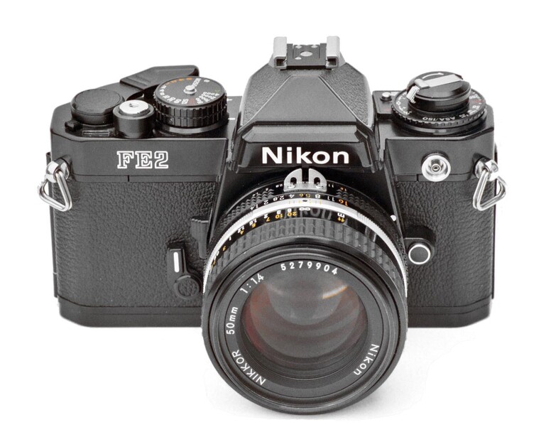 Nikon FM2 film camera with 50mm lens, viewed from front and slightly above against white background.