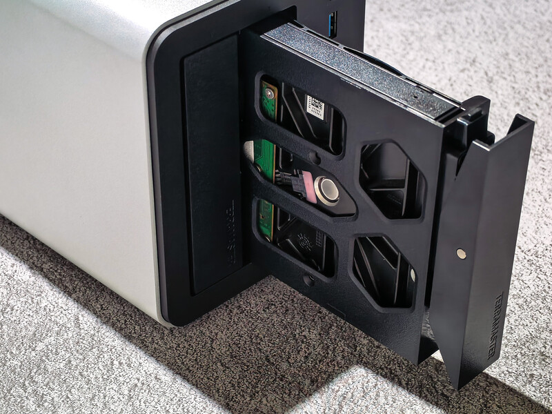 Open organizer case displaying modular storage compartments with camera accessories and small equipment.