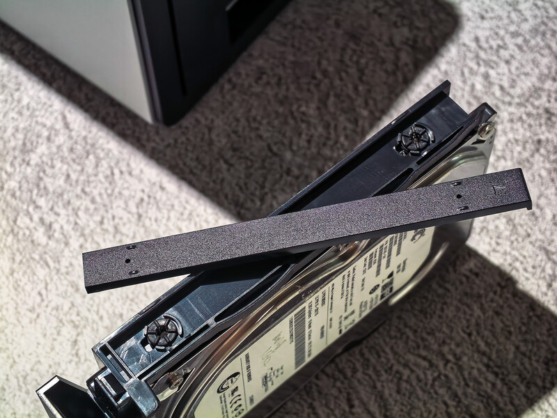 Camera neck straps and lens caps arranged on carpet with packaging boxes.