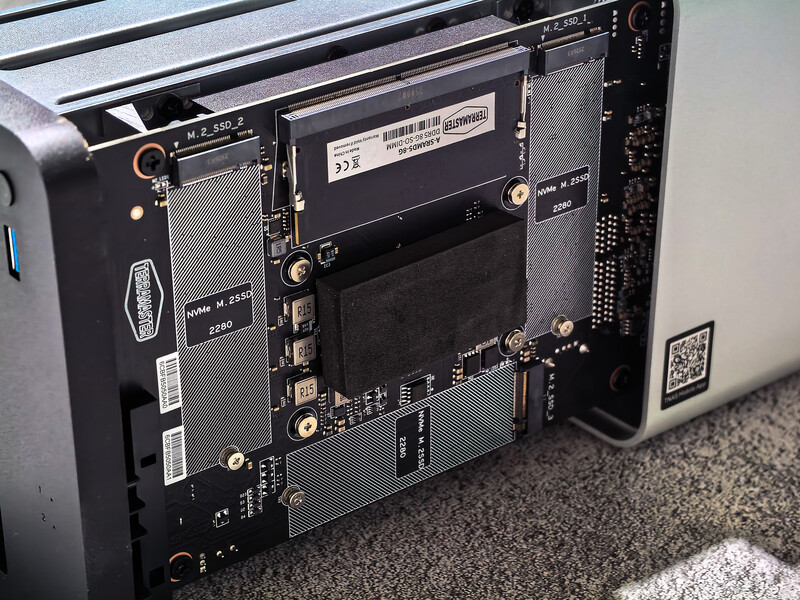 Interior view of a computer tower showing motherboard, storage drives, and power supply components.